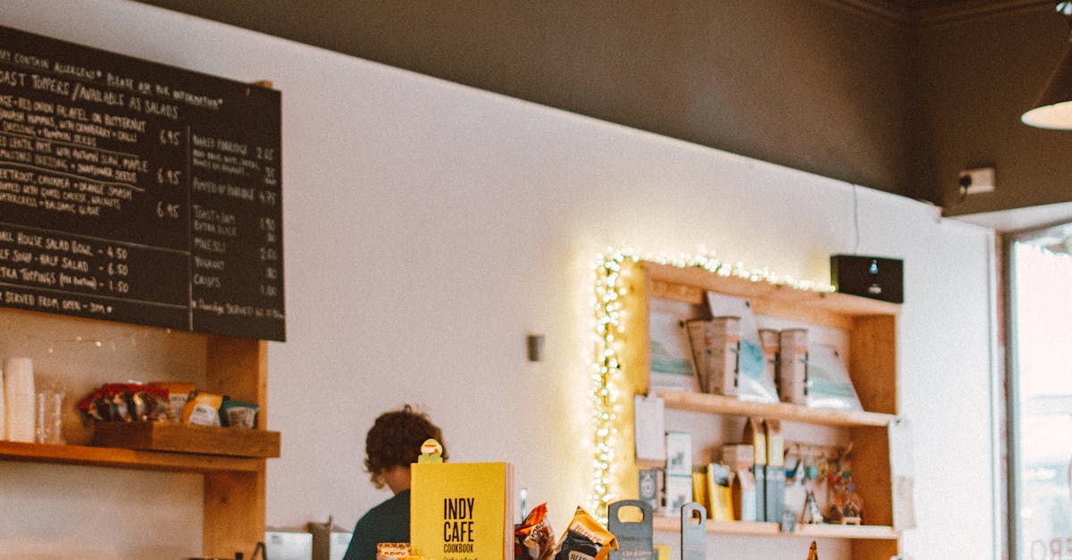 Warm and inviting café interior featuring a counter, displayed menu board, and various food items.
